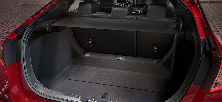 2027 Honda Civic Hatchback Sport Touring Hybrid spacious cargo area with rear seats up and cargo cover (Compact Hatchback).